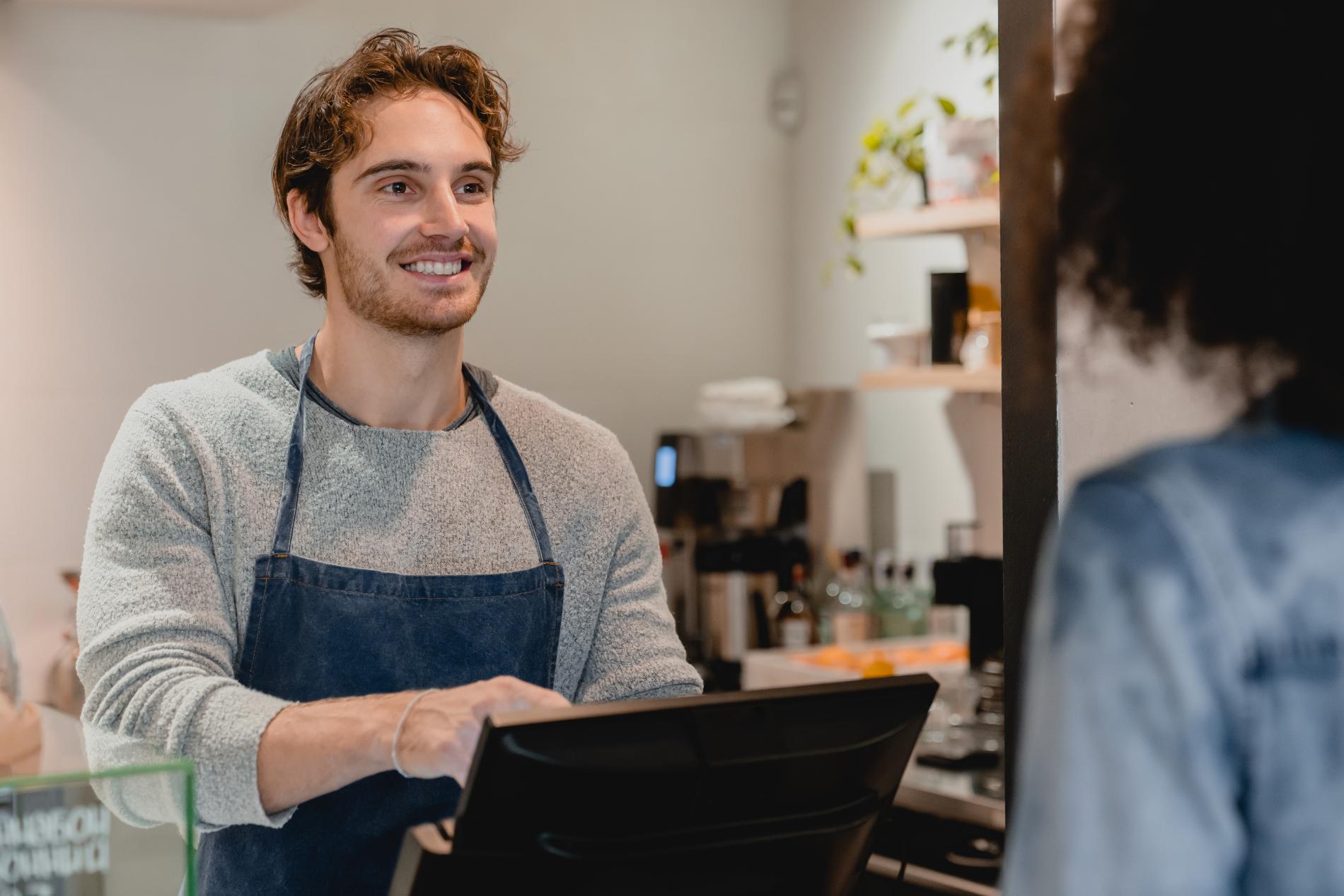 smiling-helpful-young-waiter-servicing-the-custome-2022-07-06-23-03-01-utc laitteet ja ohjelmistot